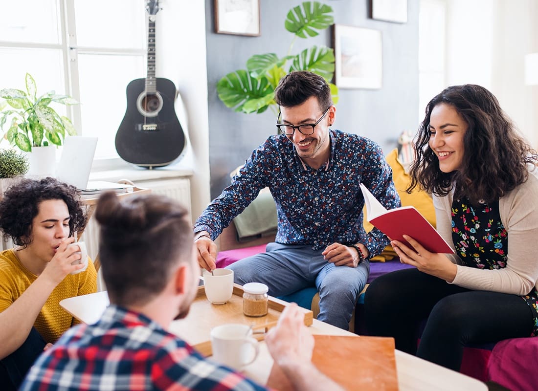 Off-Campus Student Housing Insurance - A Group of Young College Friends in the Living Room at Their Off-Campus Home